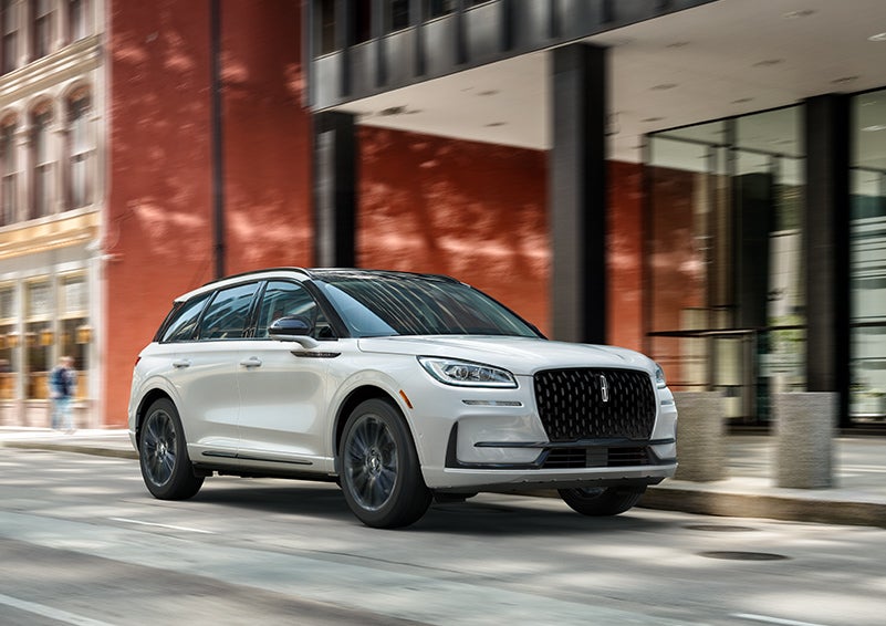 The 2024 Lincoln Corsair® SUV with the Jet Appearance Package and a Pristine White exterior is parked on a city street. | Bayway Lincoln in Houston TX