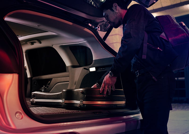 A man is shown loading cargo into the rear of a 2024 Lincoln Corsair® SUV with the second-row seats folded flat. | Bayway Lincoln in Houston TX