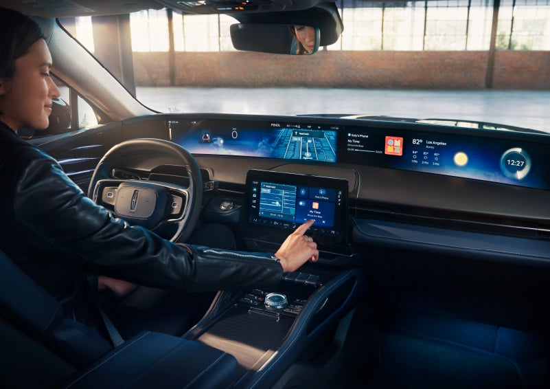 The driver of a 2024 Lincoln Nautilus® SUV interacts with the center touchscreen. | Bayway Lincoln in Houston TX