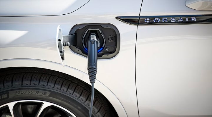 An electric charger is shown plugged into the charging port of a Lincoln Corsair® Grand Touring
model. | Bayway Lincoln in Houston TX