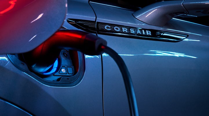 A charger plugged into the charging port of a 2024 Lincoln Corsair® Plug-in Hybrid model. | Bayway Lincoln in Houston TX